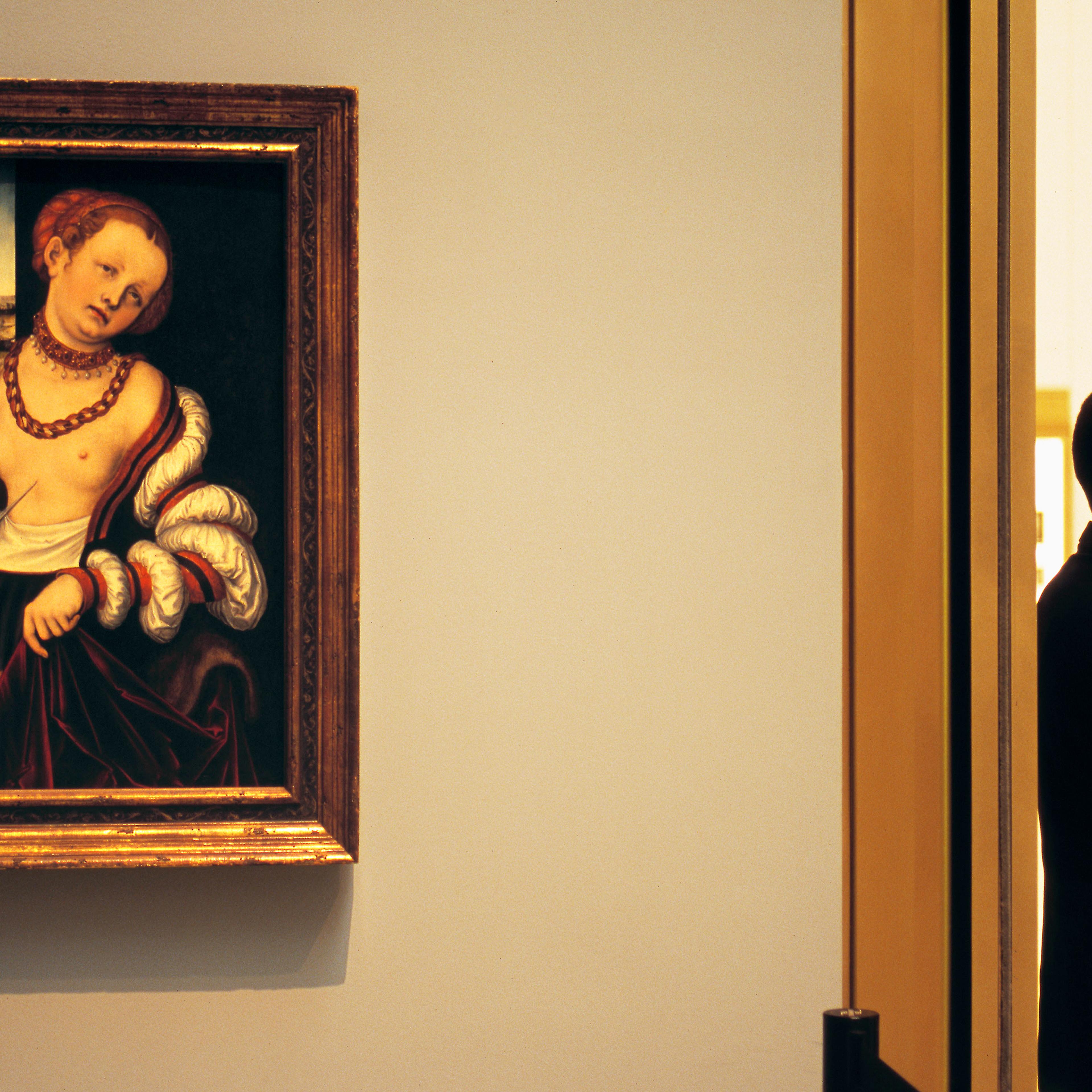 A painting on a wall with a man in a suit standing in profile beside a doorway in an art gallery.